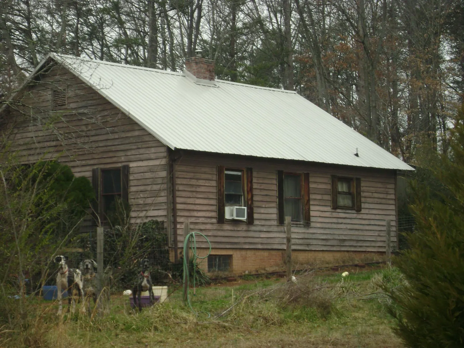 White metal roof on an old wood sided farmhouse, from a Metal Roof Installation job in Leonardville
